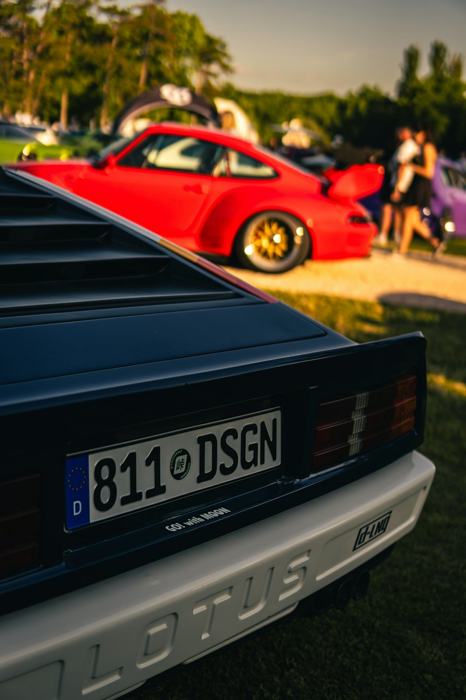Rear view of a black vintage Lotus car with license plate.
